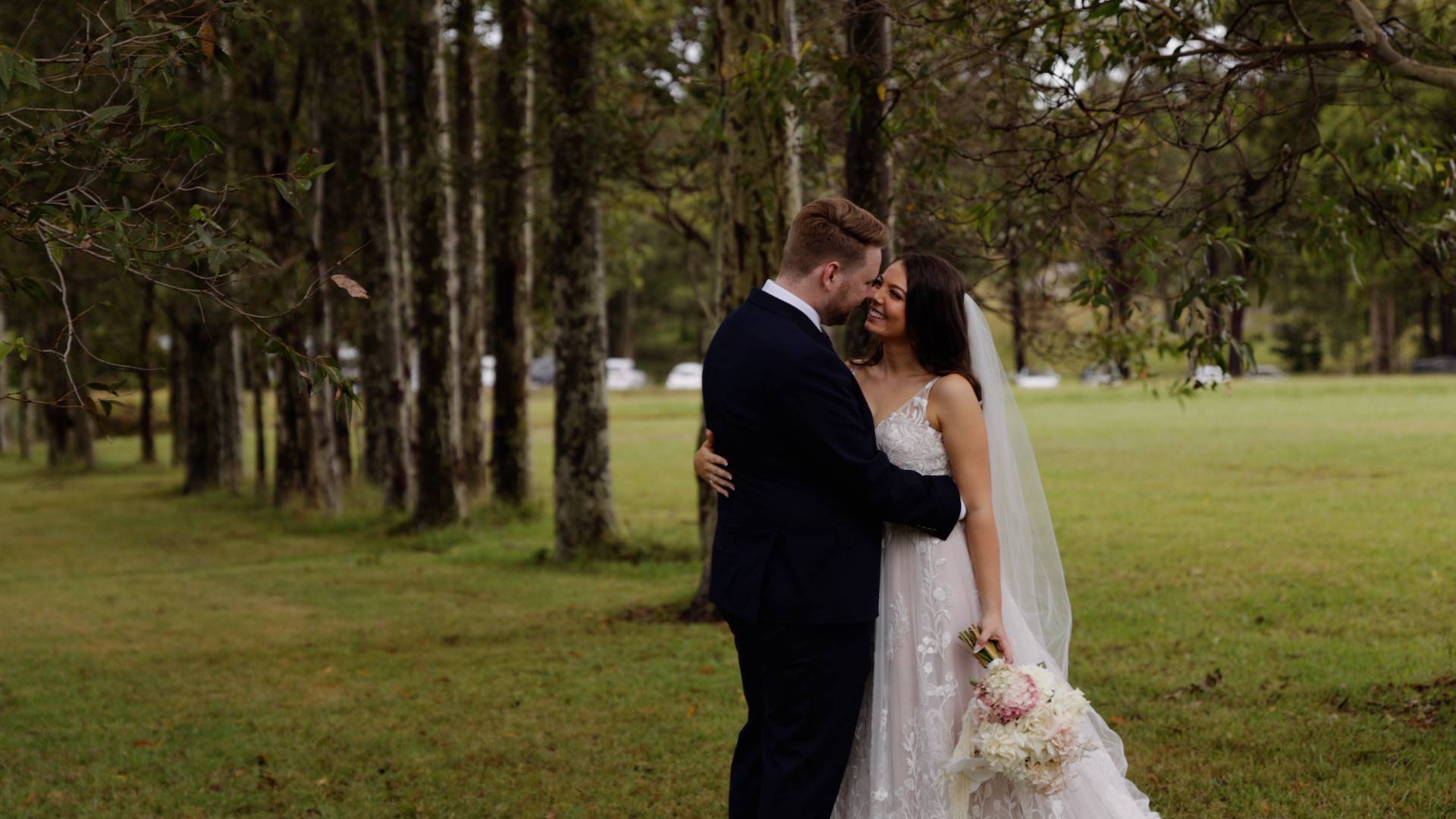 Newly married walking in a sunny orchard - photographer and wedding videographer Nowra - Lovereel