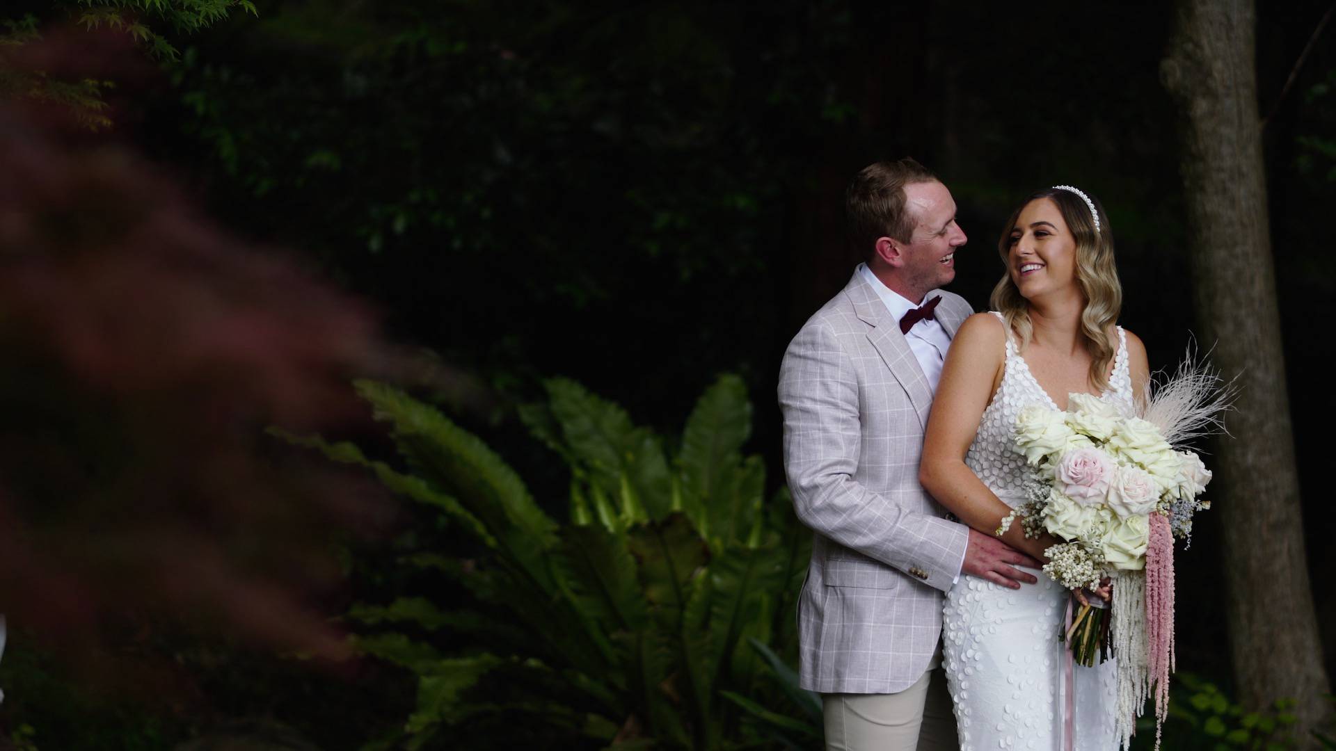Newly married couple posing among the trees - wedding videography services throughout Wollongong and South Coast NSW - Lovereel